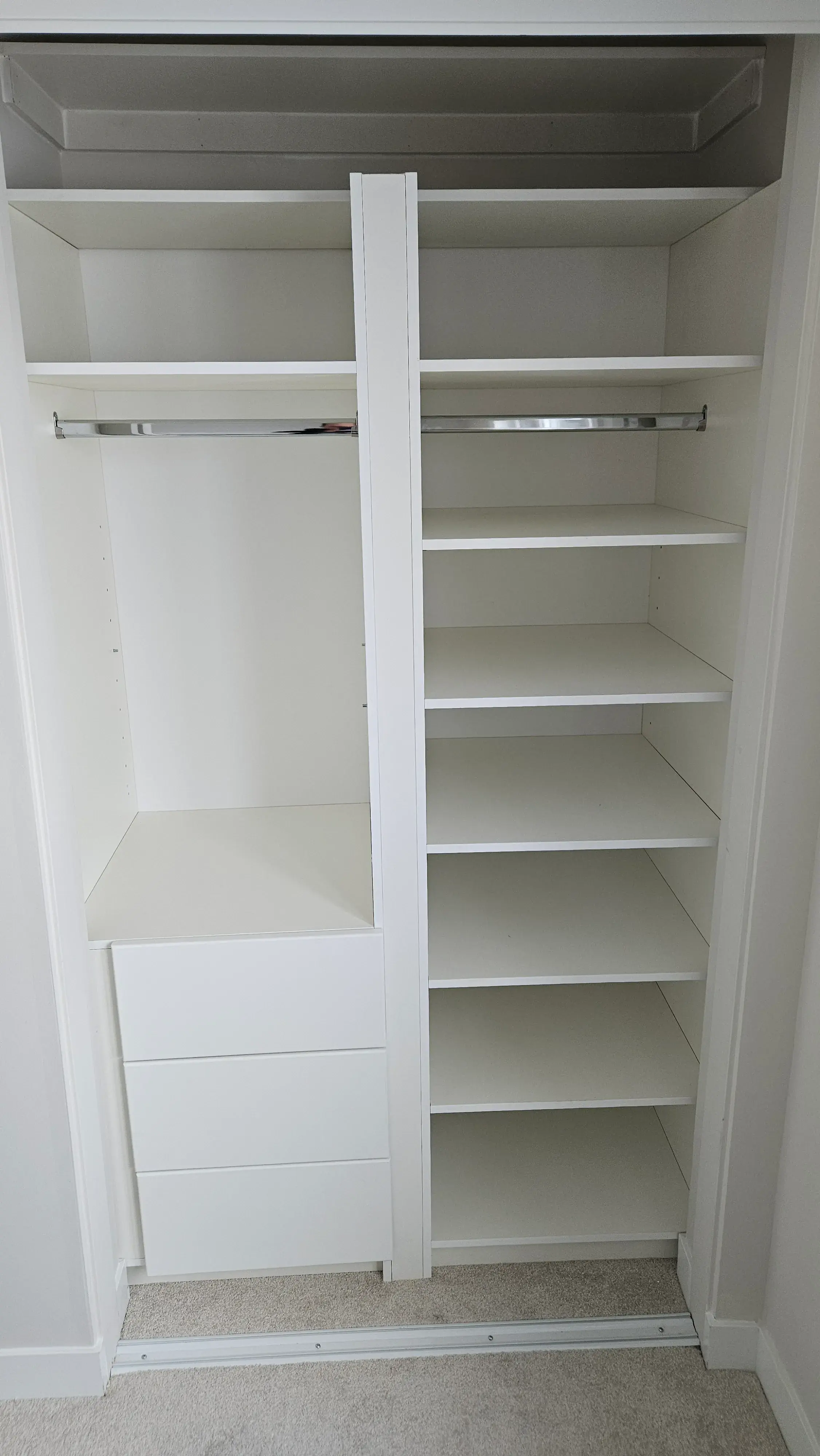 Custom reach-in closet with fitted shelving and hanging storage